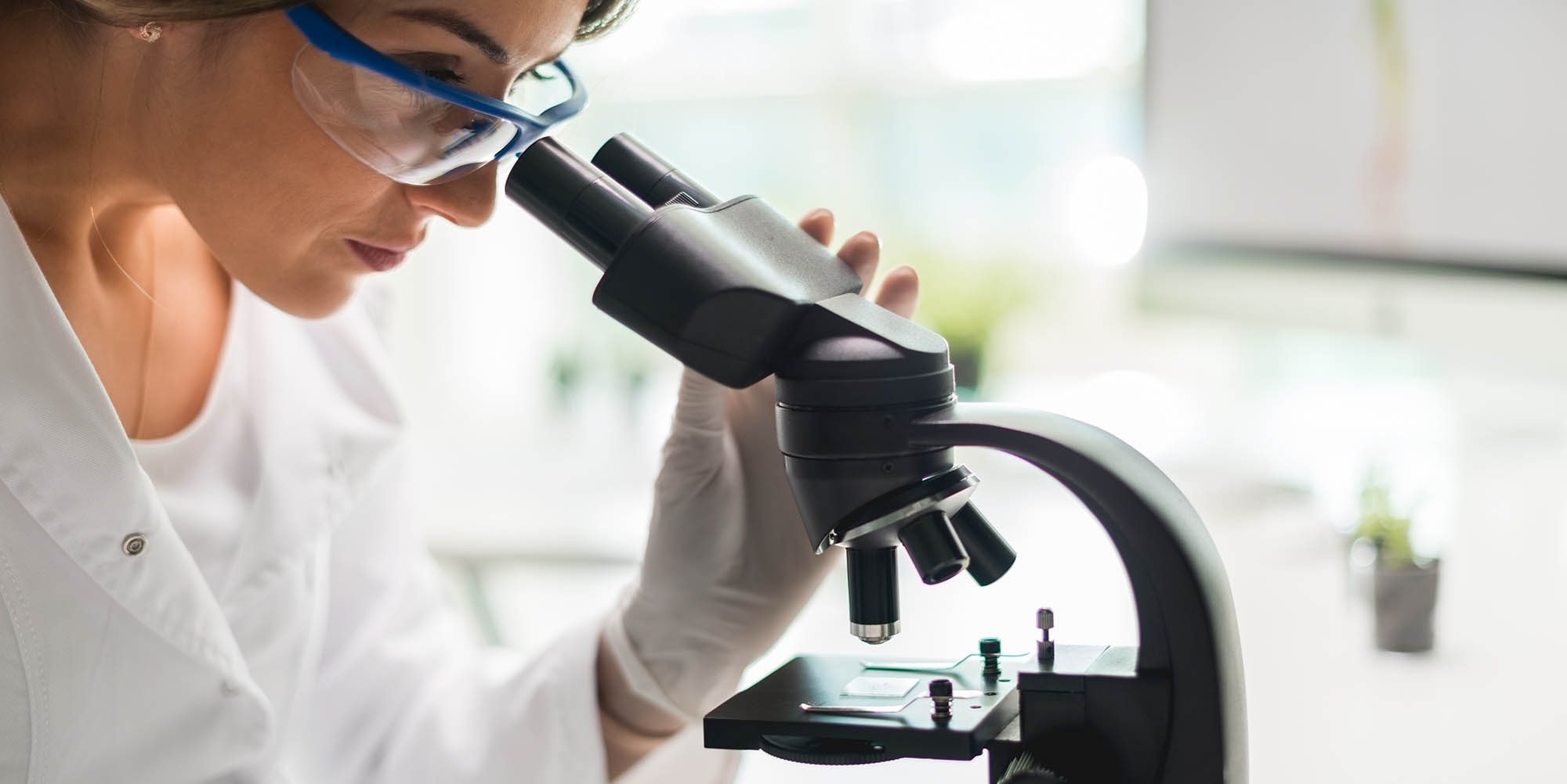 Scientist looking through a microscope
