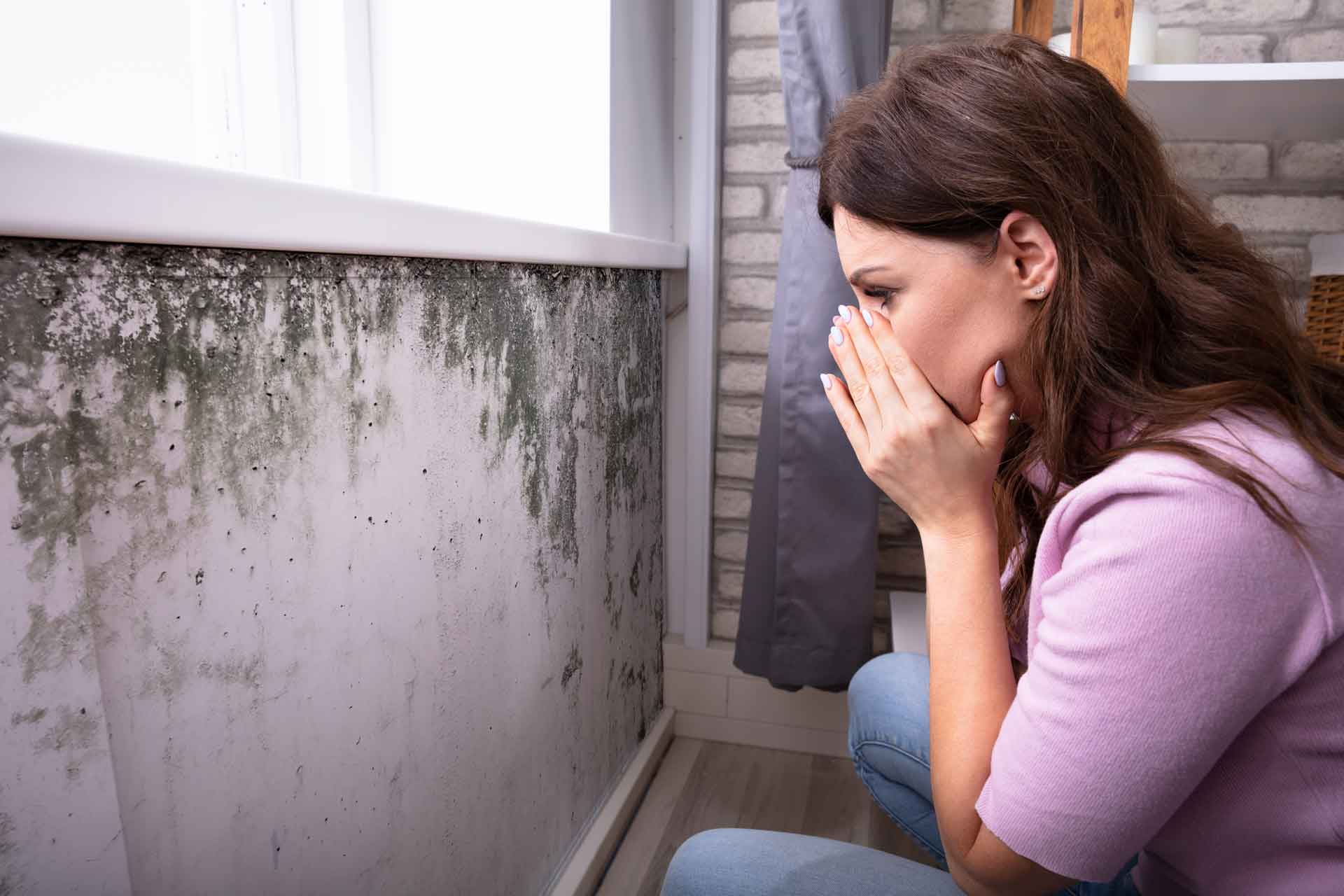 Homeowner looks in shock at mold on wall